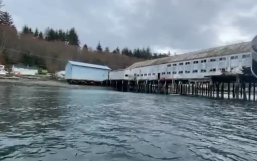A commercial pier and elevated net house standing on timber piles over water in Northern British Columbia.
