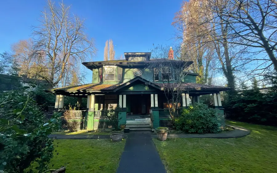 Exterior of a heritage timber home in Shaughnessy, Vancouver, seen from the garden path.